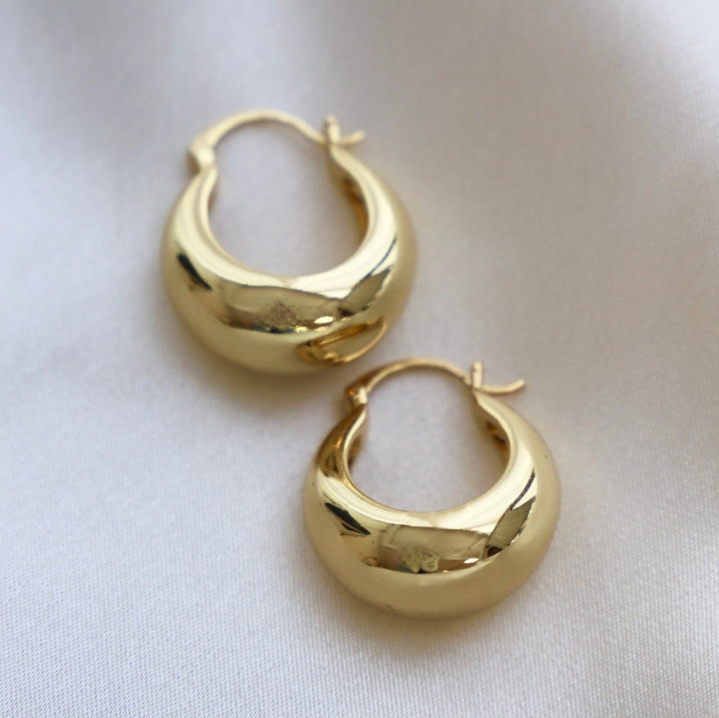 Add a touch of glamour to your look with these Coco Chunky Hoop Earrings. With a thick gold hoop design and a bold shape, these earrings add a touch of sophistication to any outfit.