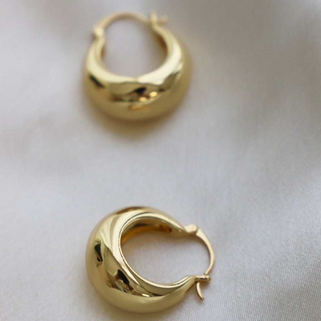 Add a touch of glamour to your look with these Coco Chunky Hoop Earrings. With a thick gold hoop design and a bold shape, these earrings add a touch of sophistication to any outfit.