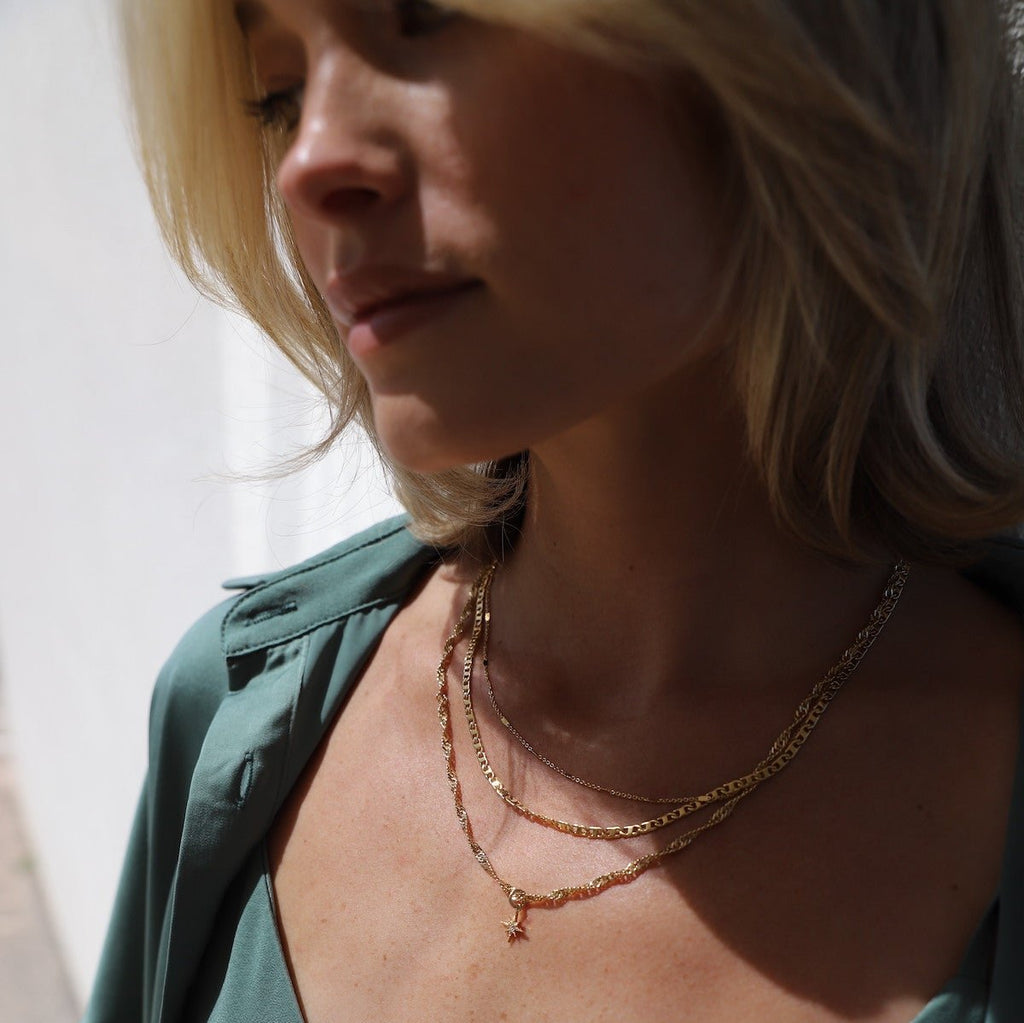 Our Janelle Necklace features a stunning twisted chain with a delicate star pendant. This piece pairs great with some of our more simpler chains or stands out beautifully on its own