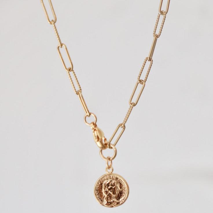 The Lora Coin Necklace is our number 1 best seller. Comprised of an elegant paperclip chain with alternating roped and smooth links. It features a small coin replica