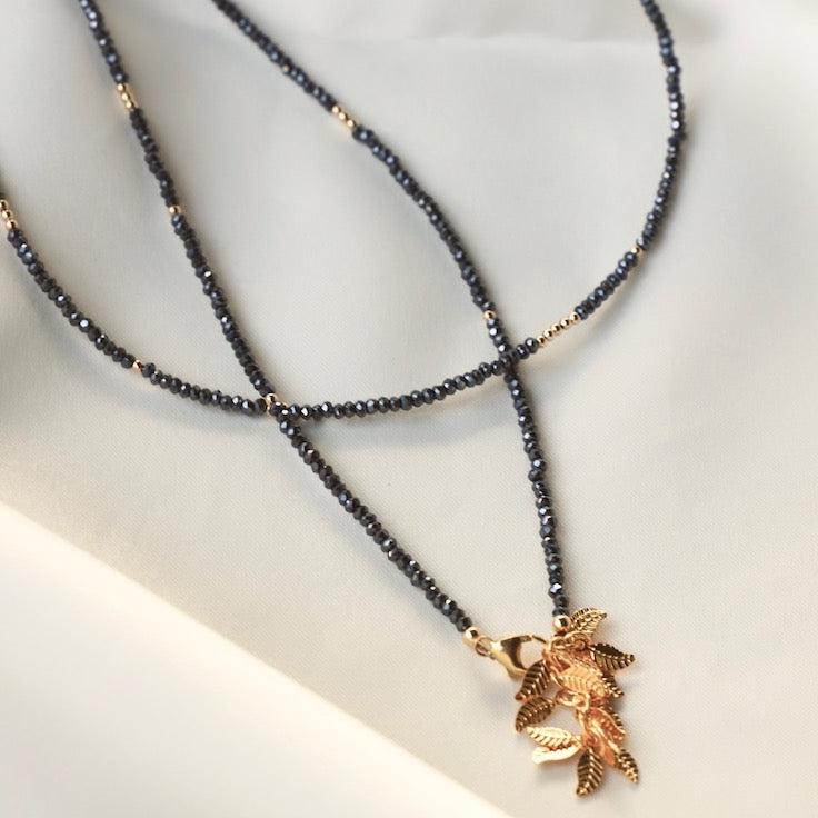 Petite hematite crystal wrap necklace with gold filled accent beads and our signature leaf chain ending. Can be worn as a wrap necklace or bracelet.