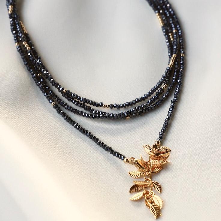 Petite hematite crystal wrap necklace with gold filled accent beads and our signature leaf chain ending. Can be worn as a wrap necklace or bracelet.