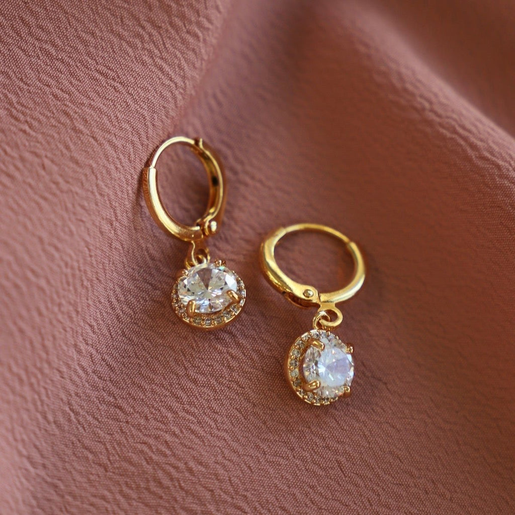 Enhance your style with our CZ Pave Round Huggies. Made with sparkling cubic zirconia, these huggie earrings add a touch of elegance to any outfit. Stand out from the crowd and elevate your look with these stunning hoop earrings.