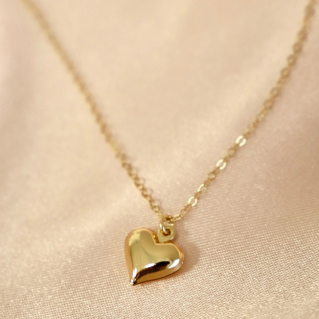 A brass puff heart charm on an 18" gold filled chain.