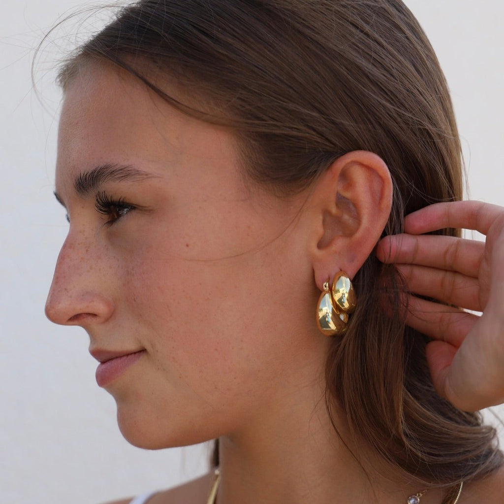 Add a touch of glamour to your look with these Coco Chunky Hoop Earrings. With a thick gold hoop design and a bold shape, these earrings add a touch of sophistication to any outfit.