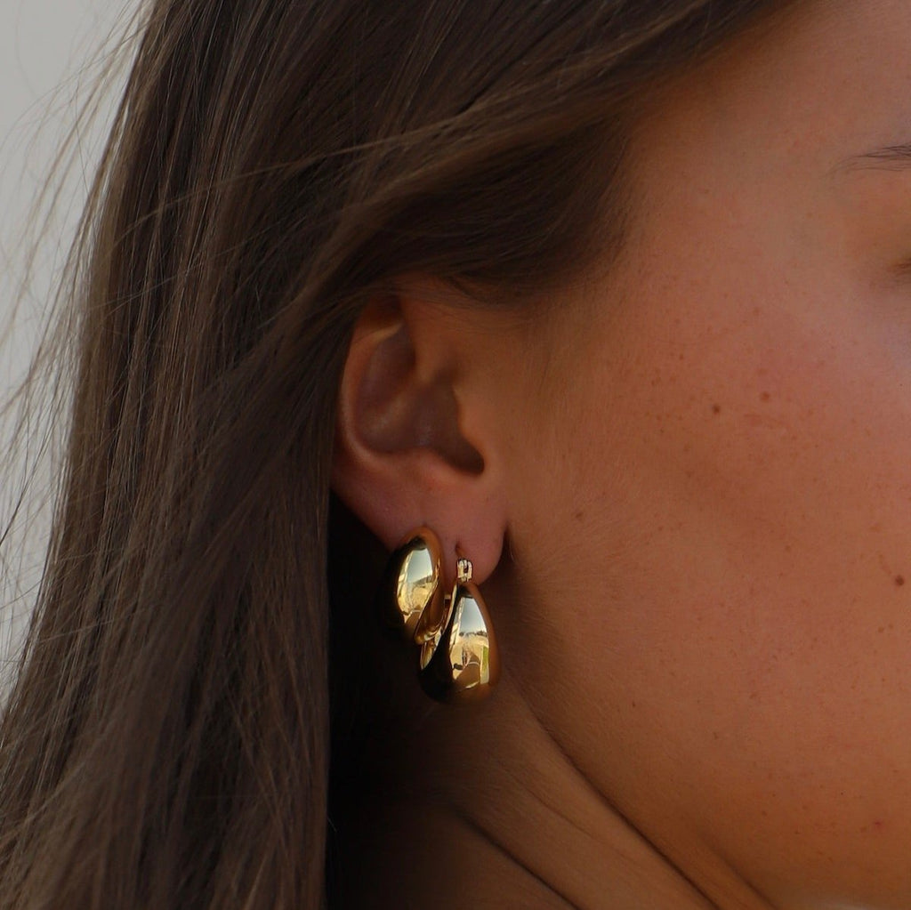 Add a touch of glamour to your look with these Coco Chunky Hoop Earrings. With a thick gold hoop design and a bold shape, these earrings add a touch of sophistication to any outfit.