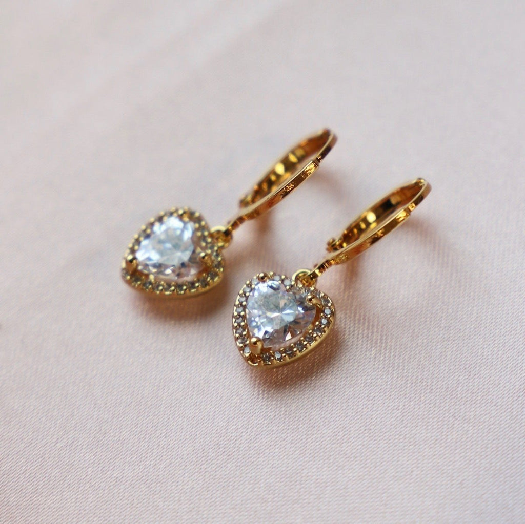 These elegant and timeless earrings feature sparkling CZ pave hearts, adding a touch of romance to any outfit. Crafted with precision and quality, these huggie earrings are perfect for any occasion.