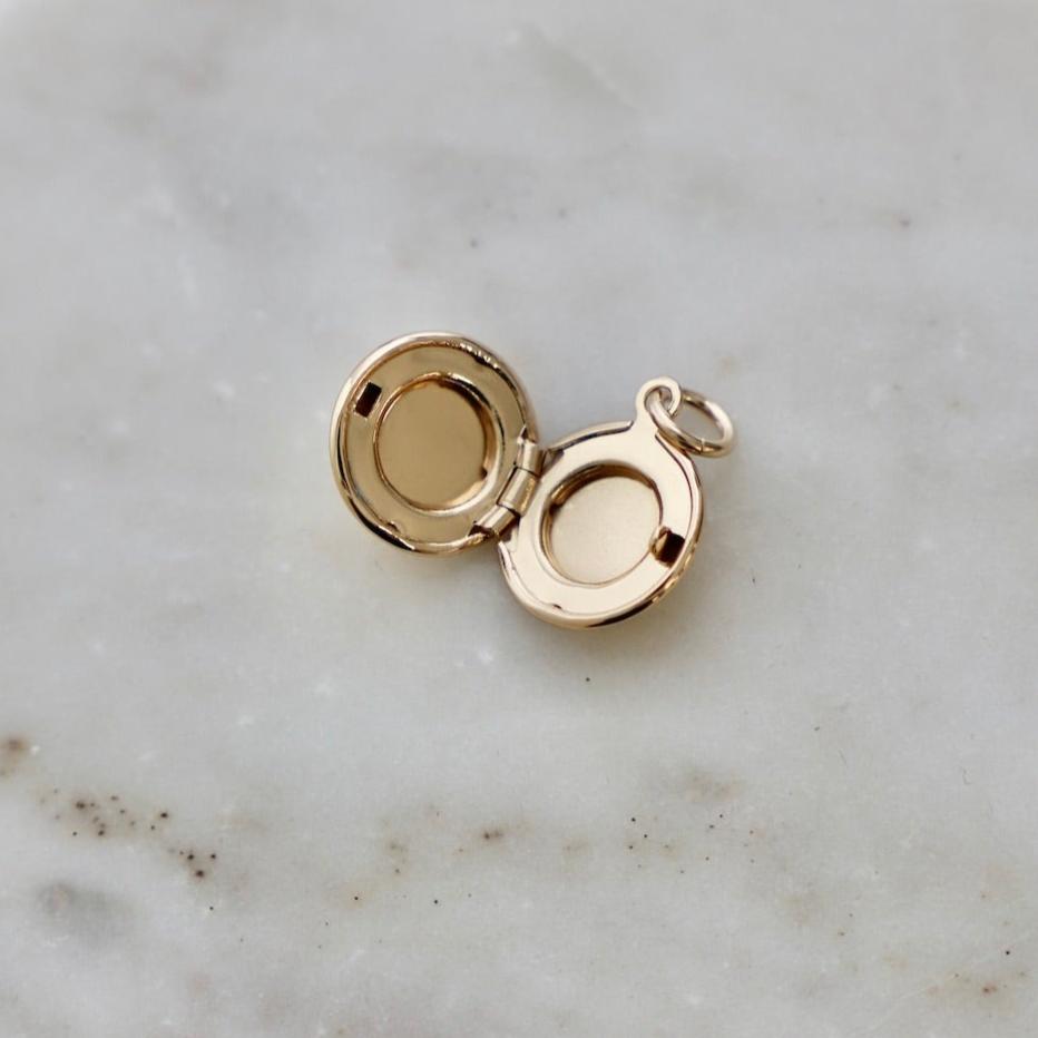 Add a buzz of personality to your jewelry collection with our Bee Locket Charm! This unique charm features a playful bee design and is perfect for storing tiny keepsakes. Make a statement with our Bee Locket Charm today!