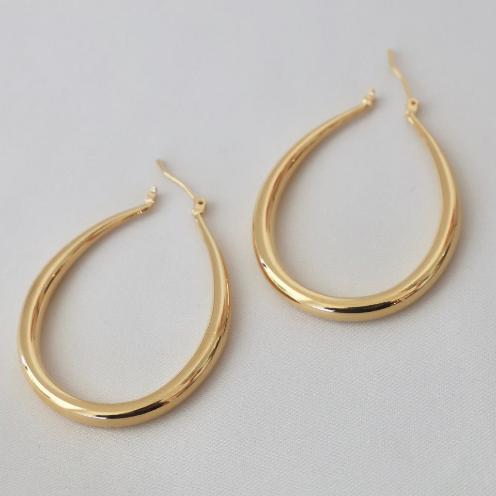 Add a touch of whimsy to your wardrobe with our Large Teadrop Hoop Earrings! These earrings feature a unique teardrop shape that adds a playful twist to any outfit. Lightweight and versatile, they're perfect for everyday wear or a night out on the town. Don't miss out on this one-of-a-kind accessory! Gold