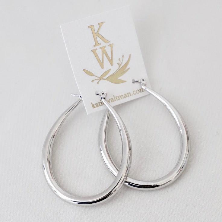 Add a touch of whimsy to your wardrobe with our Large Teadrop Hoop Earrings! These earrings feature a unique teardrop shape that adds a playful twist to any outfit. Lightweight and versatile, they're perfect for everyday wear or a night out on the town. Don't miss out on this one-of-a-kind accessory! In silver