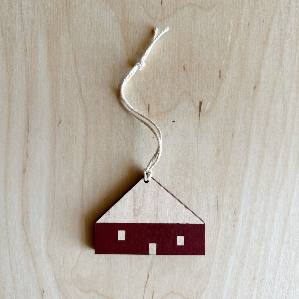 wooden house ornament with walls painted maroon