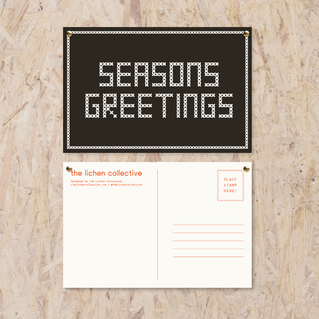 Black postcard reading "seasons greetings" in a white cross stitch-like font