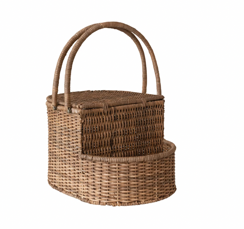 This picnic basket is a beautiful and functional piece that will enhance the home with its natural charm. The picnic basket is made of rattan wicker, an eco-friendly and durable material handwoven by skilled artisans. The wicker has an oval shape and a natural color that adds texture and warmth to any space. The picnic basket also has an open side compartment that provides extra storage space for the items. The picnic basket has two handles that make it easy to carry and move. 17"L x 12"W x 10"H