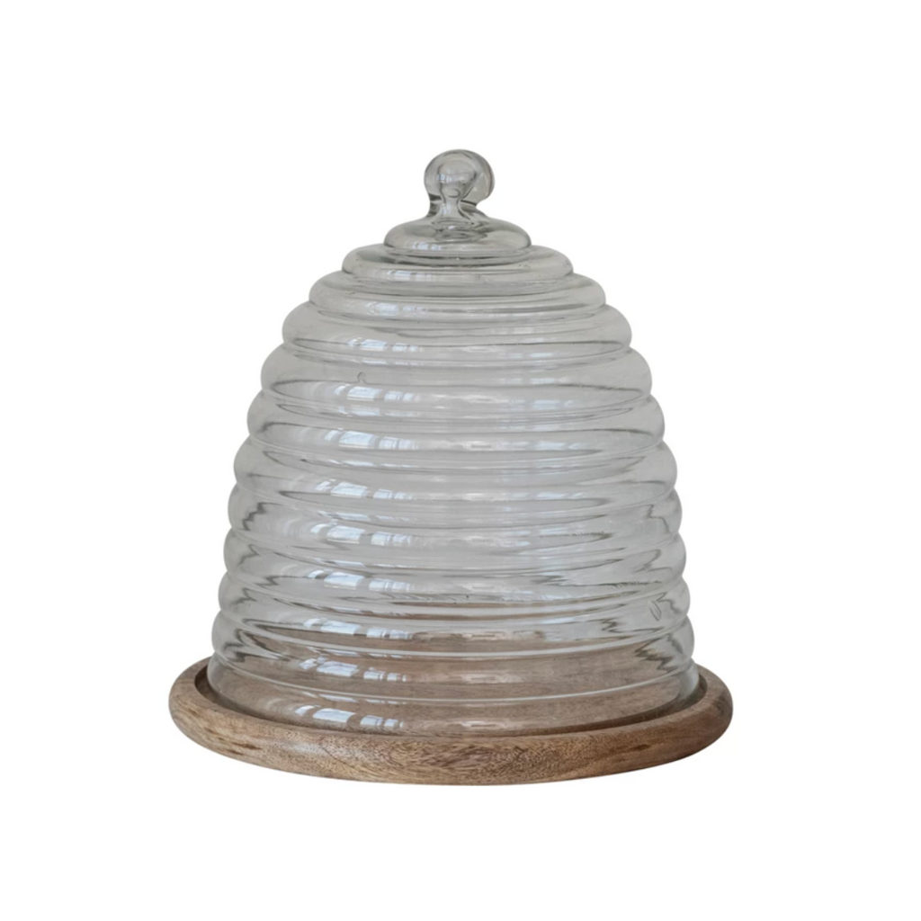 Introducing our set of two recycled glass beehive cloches with a mango wood base - the perfect eco-friendly addition to your home. Each beehive-shaped cloche is handcrafted from recycled glass and paired with a sustainably-sourced mango wood base. Keep your food and decor fresh while helping to save the bees! 11" Round x 11-1/2"H