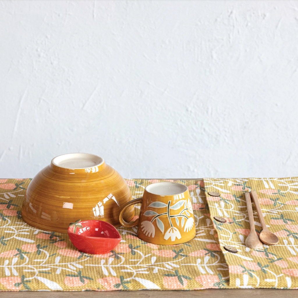 This dish drying mat is not just a practical kitchen item but also a charming addition to any space. It features a quilted terry cloth insert for extra cushioning and protection, while the outer layer is made of pure cotton with a strawberry pattern. The mat also features three coconut shell buttons for easy storage. 26"L x 18"W