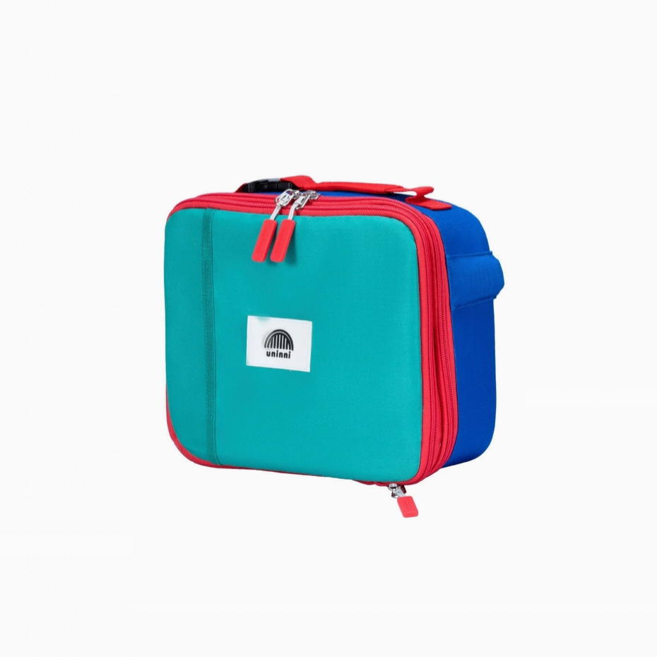 Take flight with the Ellis Lunch Bag in blue color block! This unique lunch bag features a playful blue color block design, perfect for kids or anyone with a sense of adventure. Keep your lunch fresh and cool while showing off your fun personality.&nbsp;&nbsp;