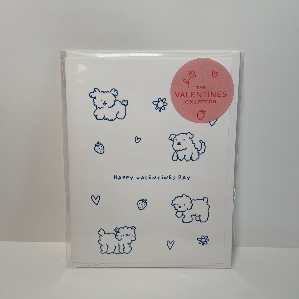 white valentine's card with blue doodles of dogs, hearts, flowers, and strawberries