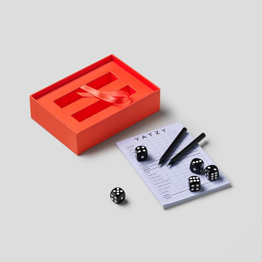 Discover a modern twist to your beloved game, Yatzy, where aesthetics meet entertainment. Our Yatzy Classic includes five black dice, two black pencils, and a 50-page scorecard. It has easy-to-read English, French, and German instructions and is suitable for up to 6 players, ages 4+