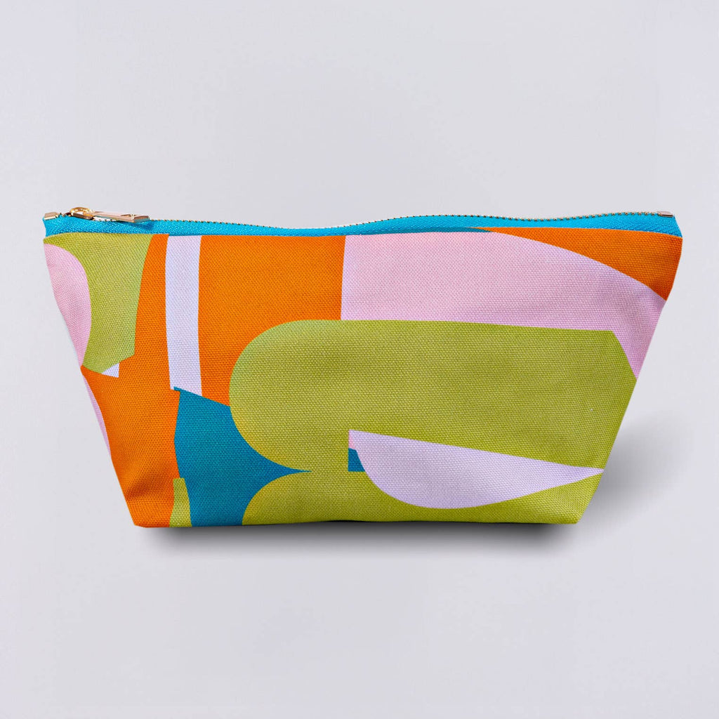 Pencil case or cosmetic pouch? You decide! This is perfect for either and it's made with lovely cotton canvas fabric and has nylon lining. Features an abstract print and a contrast colour brass metal zip. Measures 26cms wide at the top, 13cms height and 9.5cms wide at the base. Machine washable as well, so it's easy to look after. Made in the UK.