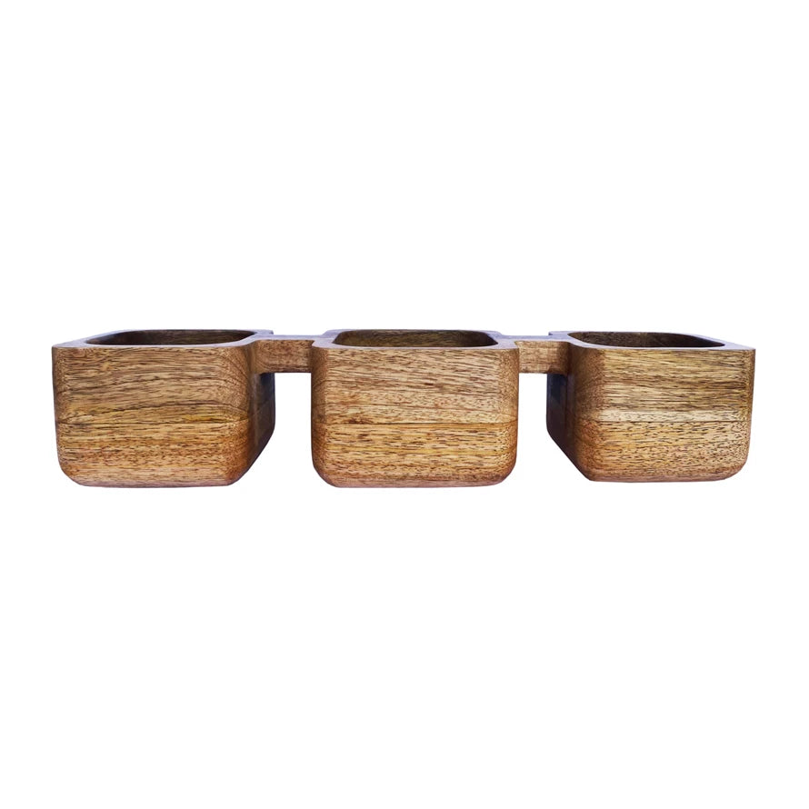 This natural mango wood dish with 3 sections is a simple and elegant addition to the tableware. The natural mango wood base and three sections provide a warm and cozy feel, while the simple and sleek design adds a contrast and sophistication. The dish is a versatile choice for adding a touch of Scandinavian, boho, global, or modern style to the tableware. Use it to serve dips, sauces, nuts, candies, or any other small snacks or items.