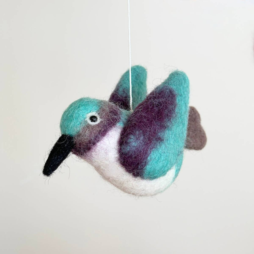 Discover our vibrant Hummingbird Baby Mobile!  Five colorful hummingbirds with dynamic wing positions dance around a white felt frame. Add a pop of brilliance and wonder to your space. A must-have for bird lovers, bringing nature's beauty right to your baby's eyes. Let imagination take flight!