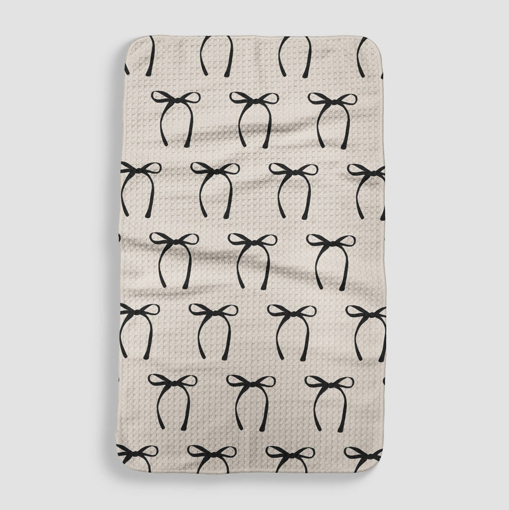 cream tea towel with a black bow pattern