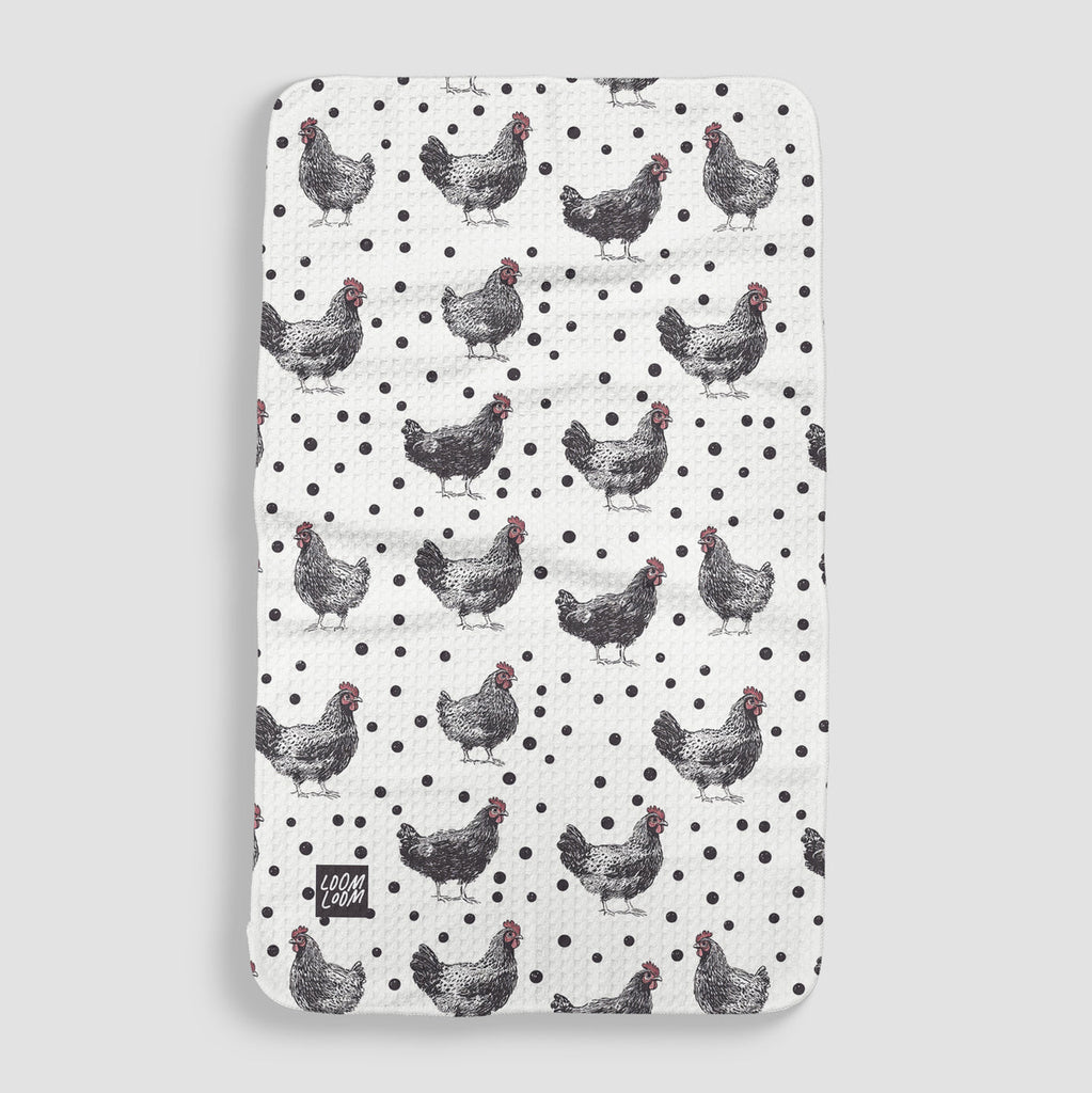 white tea towel with black polka dots and black and white chickens