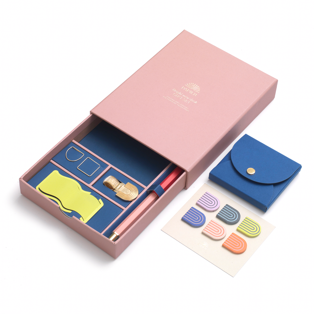 Bring a shine to your space with Papier's Bright New Desk gift set. Stay organized with a mix of Papier classics and exclusives, including: our Rollerball pen, Neon Wave bookmark, Rainbow pen clip, two paper clips, a set of six Rainbow sticky tabs, and the pocket sticky notes set. Beautifully boxed and ready to go as a gift.