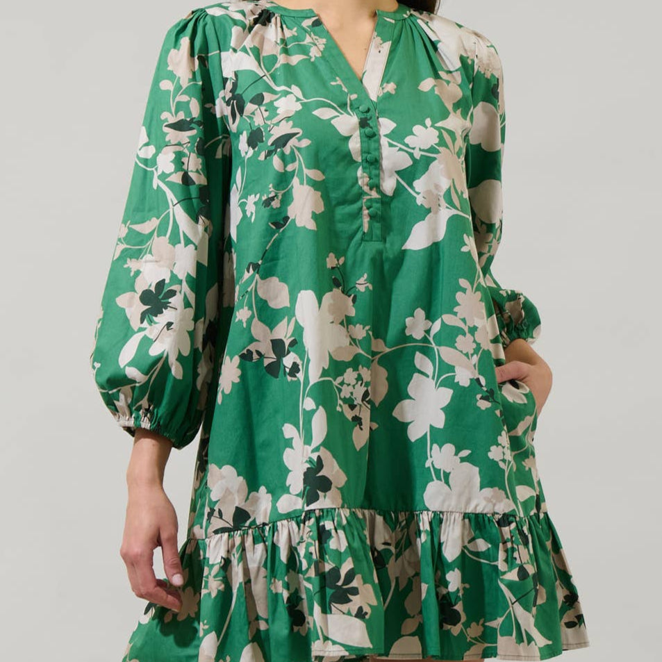 You'll be more than ready when you wear the Nora Floral Whine Shift Mini Dress. A split neckline frames long balloon sleeves with elastic bands at the end. It has a shift style with a ruffle hem at the bottom. Easy to pair with strappy heels.