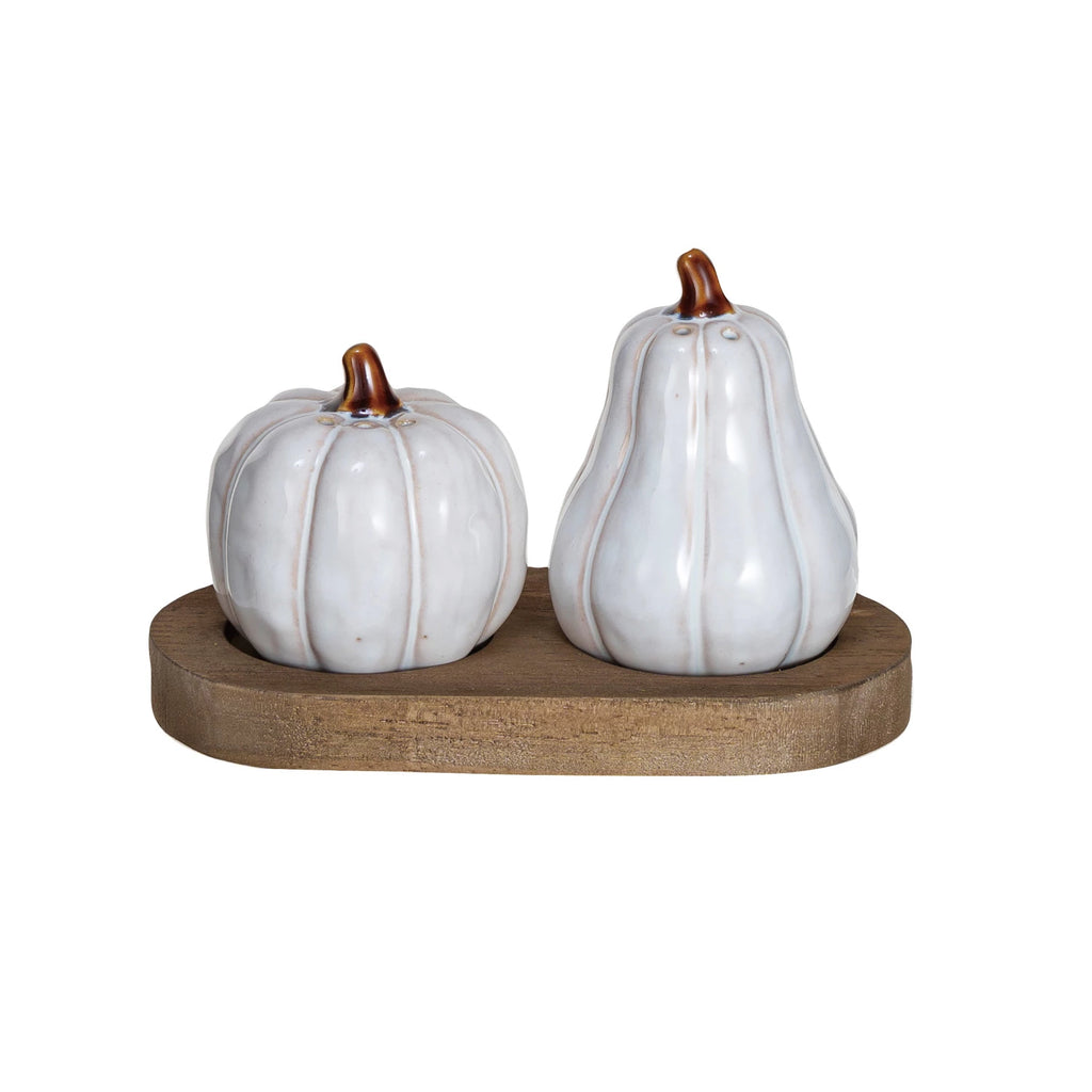 This set of two stoneware salt and pepper shakers, featuring a gourd and a pumpkin, brings the essence of the harvest season to every dining experience. The reactive glaze in white and natural tones ensures that each piece is distinct, celebrating the uniqueness of nature's bounty. The shakers sit elegantly on a wooden tray, making them a practical yet decorative addition to any meal