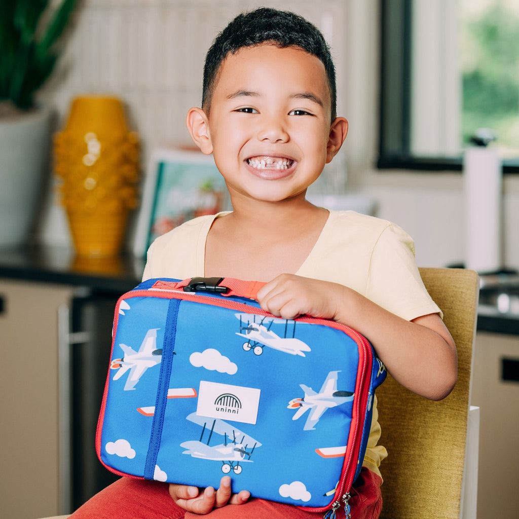 Take flight with the Ellis Lunch Bag in Airplanes! This unique lunch bag features a playful airplane design, perfect for kids or anyone with a sense of adventure. Keep your lunch fresh and cool while showing off your fun personality. Time to soar through your day!