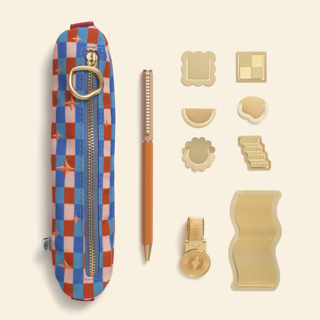 Brighten their pages with Papier’s Time to Shine gift set. This shimmering assortment will help any stationery lover save their place in style. Find gold brass accessories including the Curious paper clips and Wave bookmark, plus a slim ballpoint pen and pen clip – so taking note is never far away. Complete with a sleek, stretchy pen pouch, which can hold everything inside.