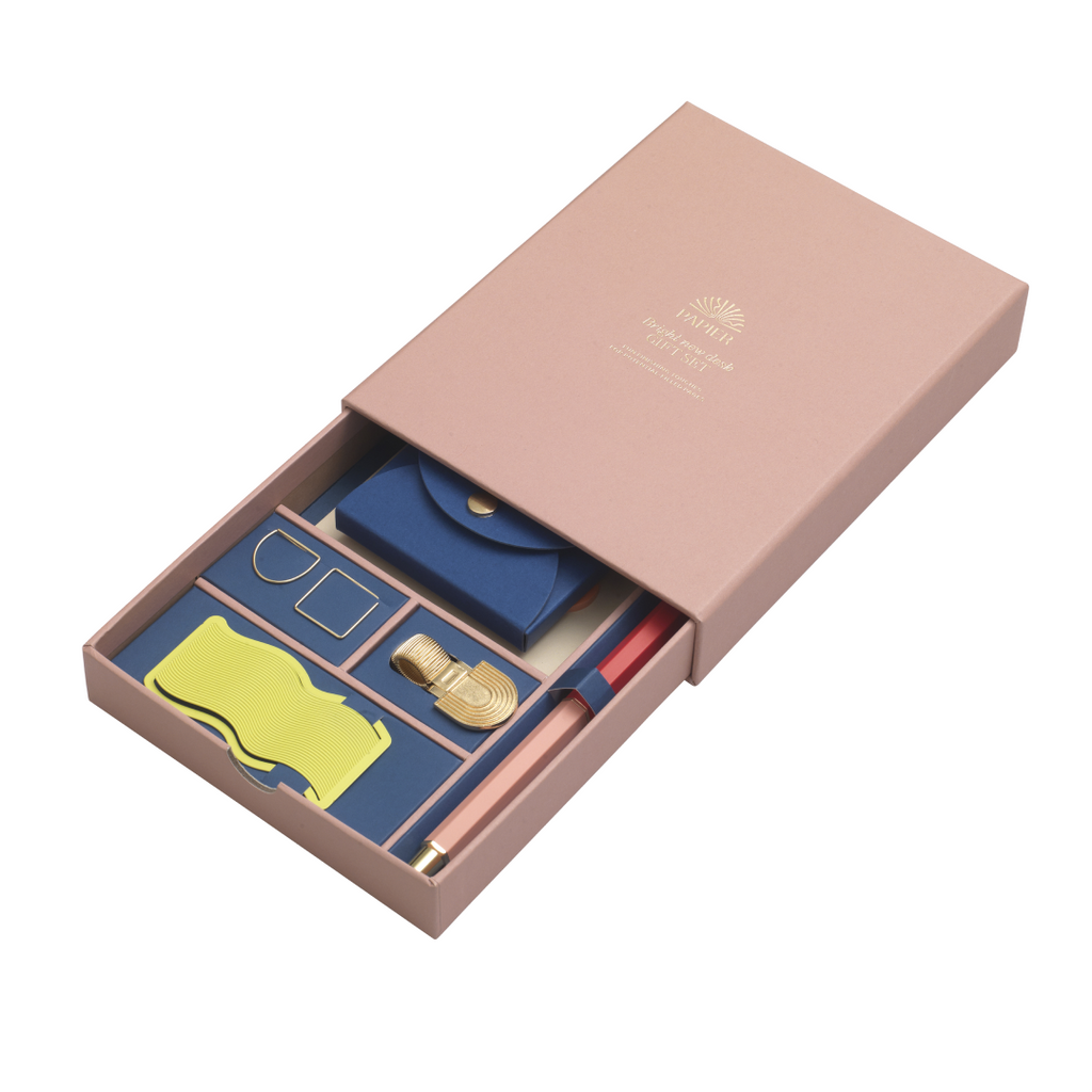 Bring a shine to your space with Papier's Bright New Desk gift set. Stay organized with a mix of Papier classics and exclusives, including: our Rollerball pen, Neon Wave bookmark, Rainbow pen clip, two paper clips, a set of six Rainbow sticky tabs, and the pocket sticky notes set. Beautifully boxed and ready to go as a gift.