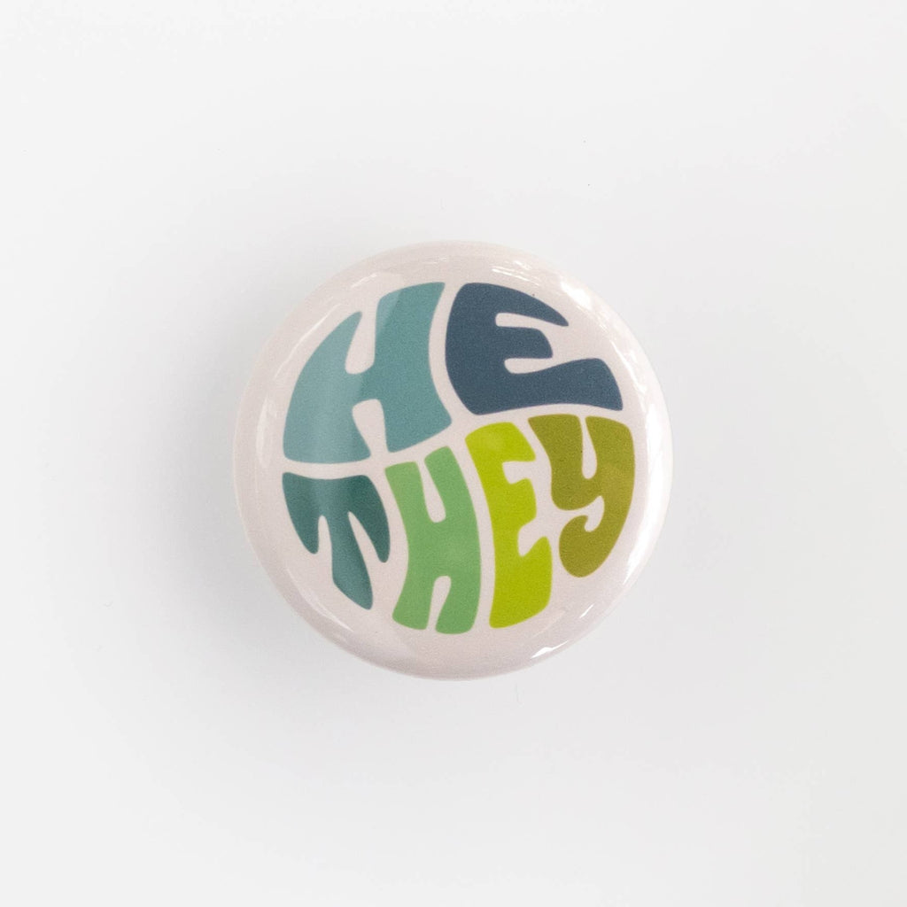 Wear your pronouns with pride with these cute retro-style buttons! This pinback button displays "He/They" pronouns in a green and blue color palette. It is the perfect way to let others know how to address you and to show your support for the LGBTQ+ community!  Size: 1.25" pinback button