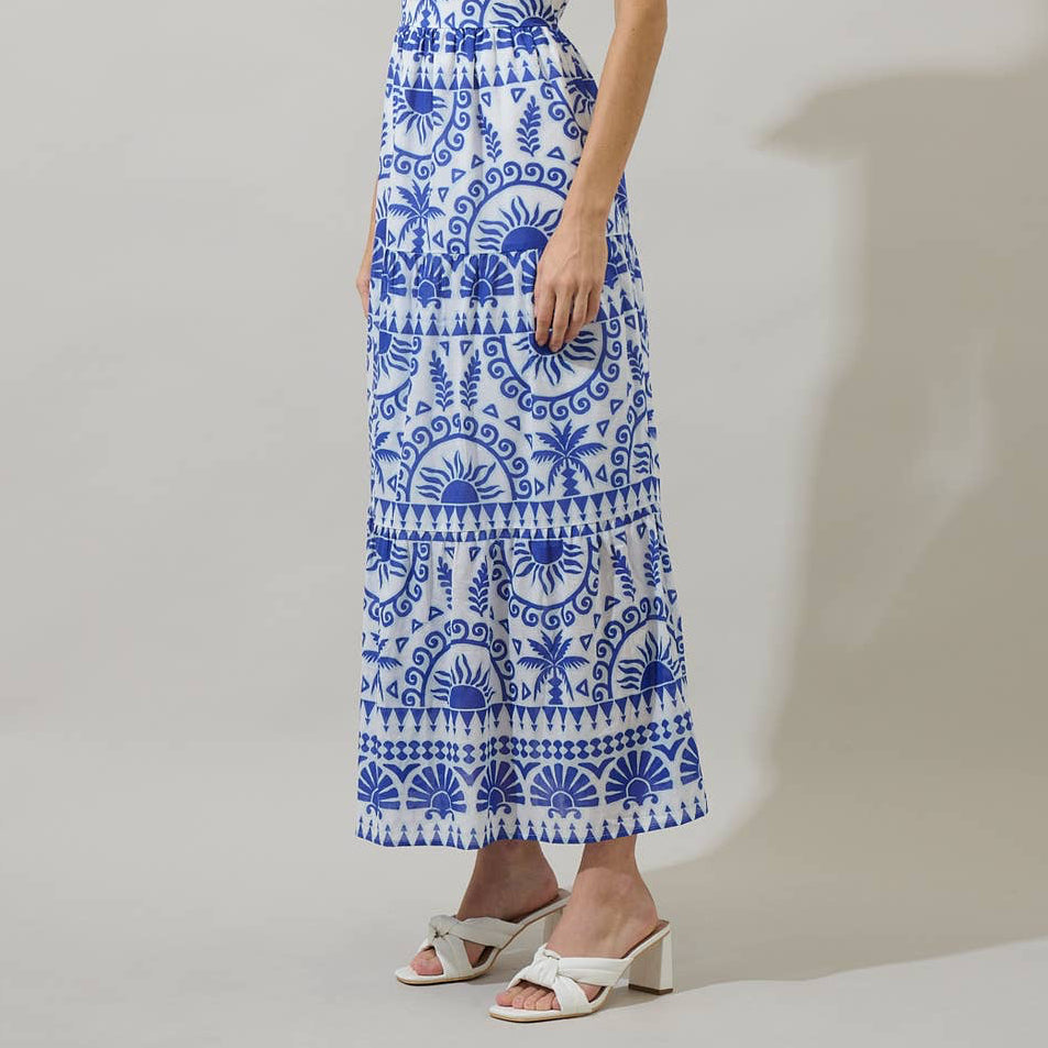 It’s easy to create a cute look when you’ve got the Rivera Tropics Emely Tiered Maxi Dress. A blue print sits on a white background creating this fun and creative print. It features shoulder tie straps, tiered layers, and a smocked back. White heels would be a perfect match to this dress.