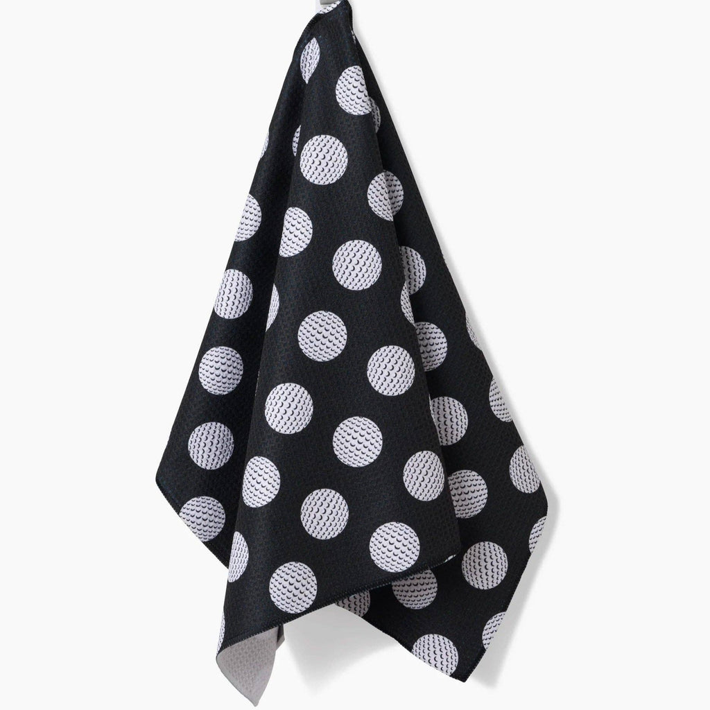 black tea towel with white golf ball polka dots