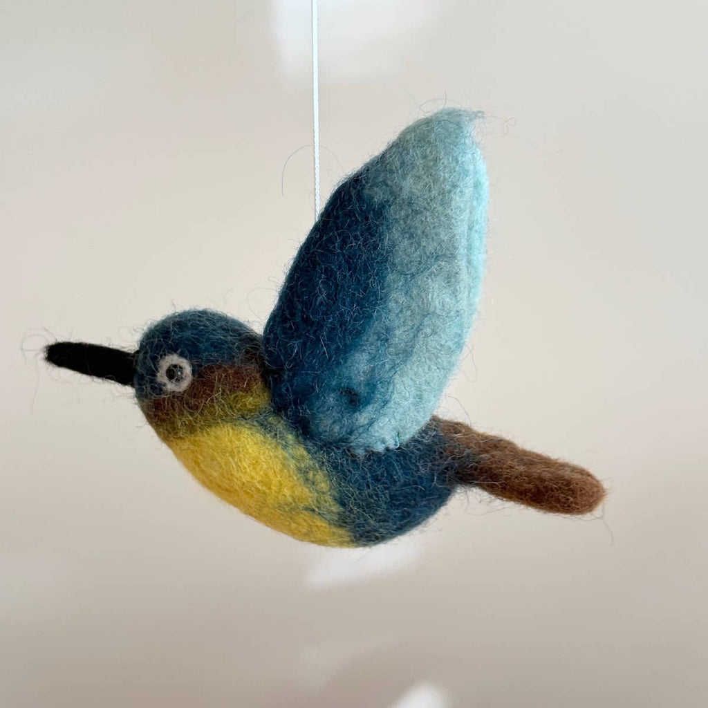 Discover our vibrant Hummingbird Baby Mobile!  Five colorful hummingbirds with dynamic wing positions dance around a white felt frame. Add a pop of brilliance and wonder to your space. A must-have for bird lovers, bringing nature's beauty right to your baby's eyes. Let imagination take flight!