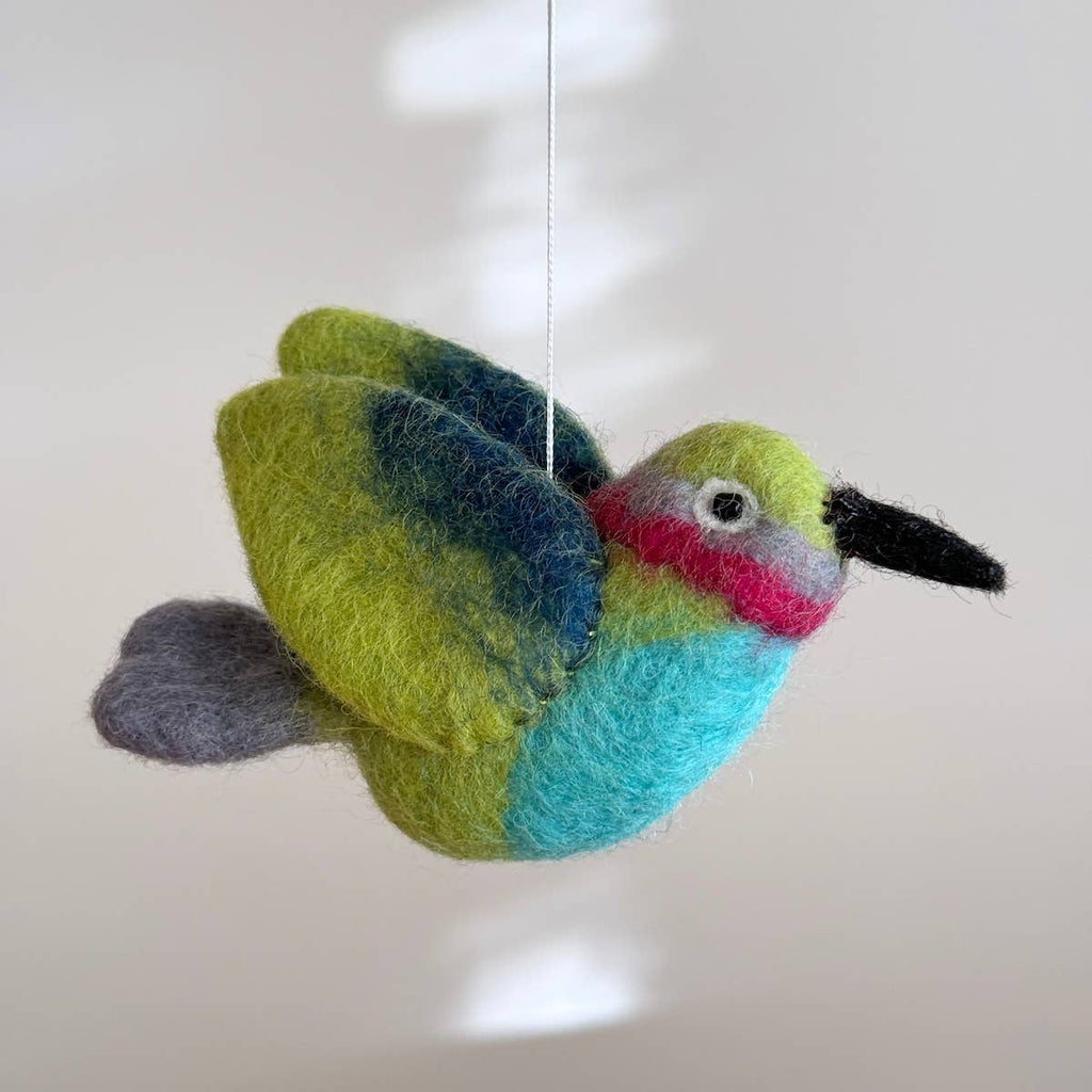 Discover our vibrant Hummingbird Baby Mobile!  Five colorful hummingbirds with dynamic wing positions dance around a white felt frame. Add a pop of brilliance and wonder to your space. A must-have for bird lovers, bringing nature's beauty right to your baby's eyes. Let imagination take flight!