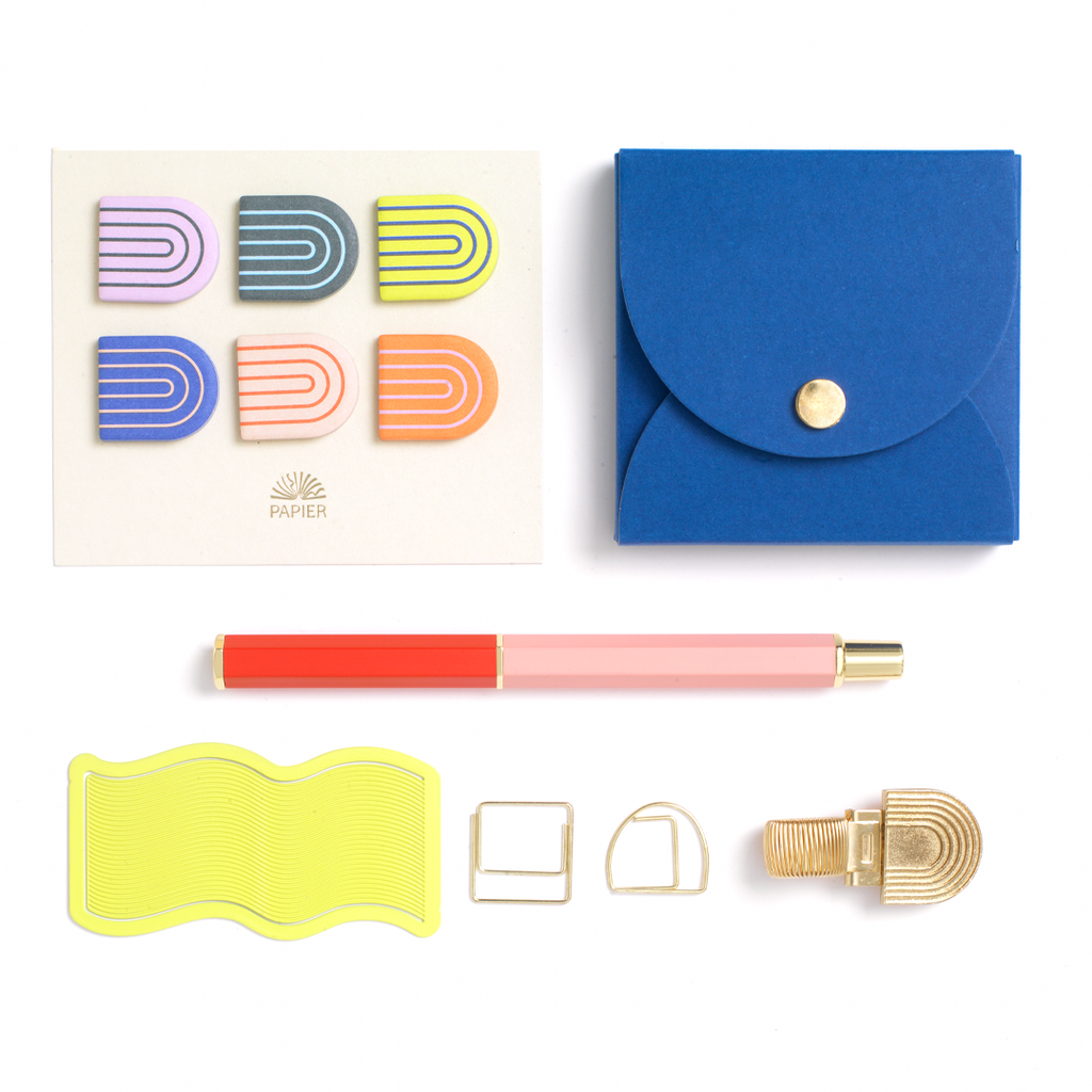 Bring a shine to your space with Papier's Bright New Desk gift set. Stay organized with a mix of Papier classics and exclusives, including: our Rollerball pen, Neon Wave bookmark, Rainbow pen clip, two paper clips, a set of six Rainbow sticky tabs, and the pocket sticky notes set. Beautifully boxed and ready to go as a gift.