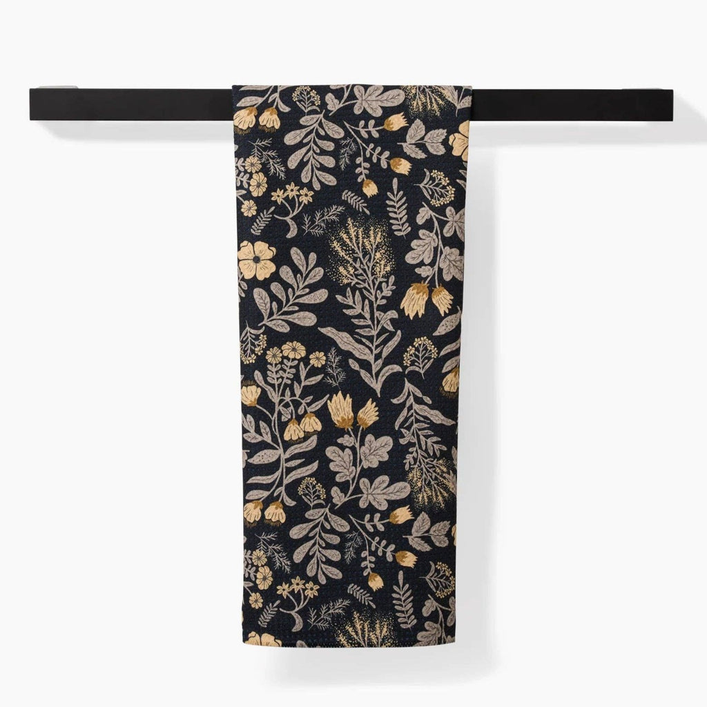 black tea towel with yellow/green floral pattern