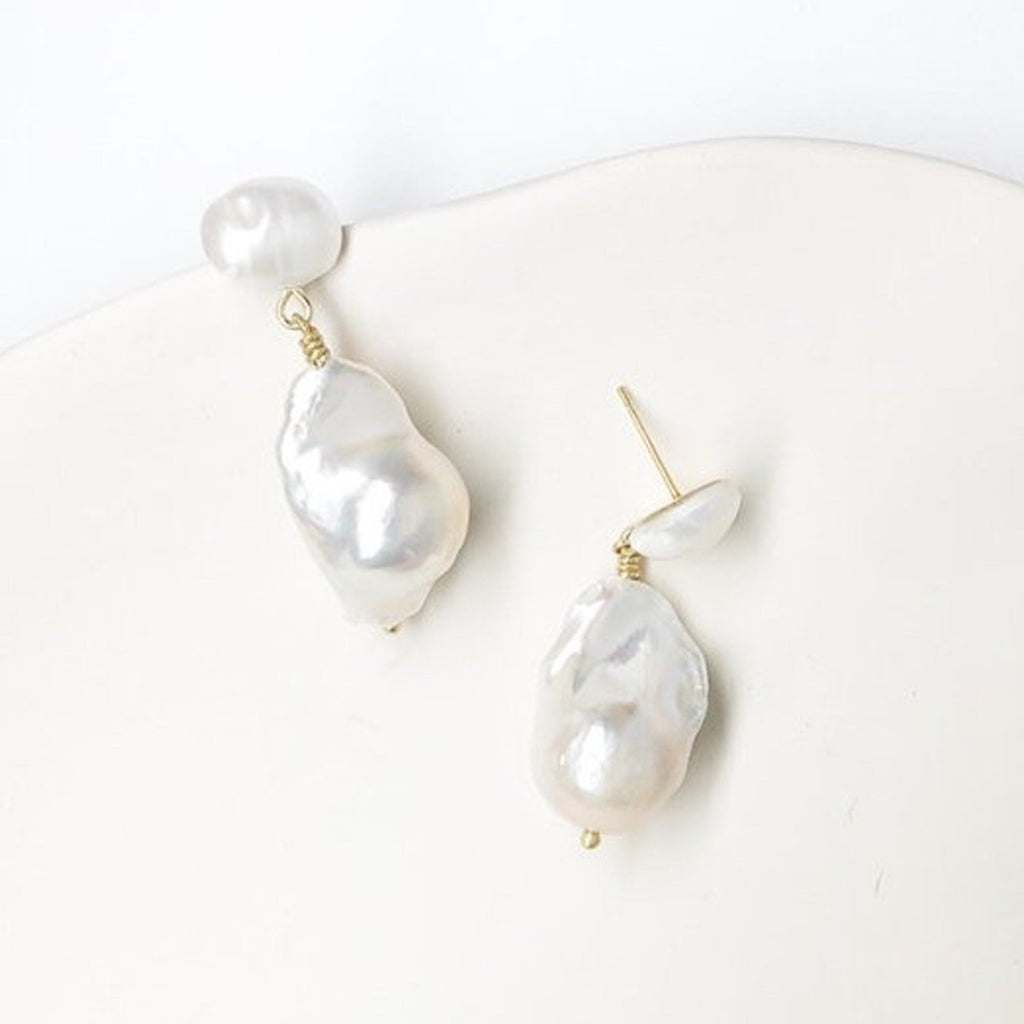 Elevate your accessory game with these natural pearl and gold plated ear posts. Enhance your ensemble with a touch of elegance and shimmer. Embrace nature's beauty and let your ears make a statement.