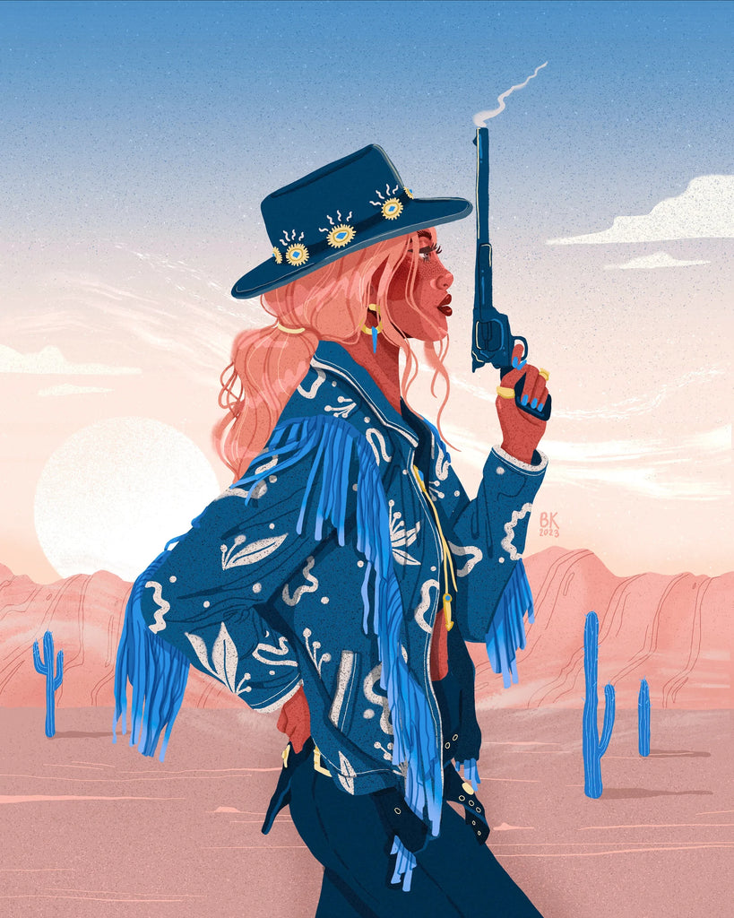 A cowgirl, wearing a cowgirl hat and denim jacket with fringe, holds a smoking gun pointed to the sky. She is In a desert with red rock, cacti, and blue sky. 