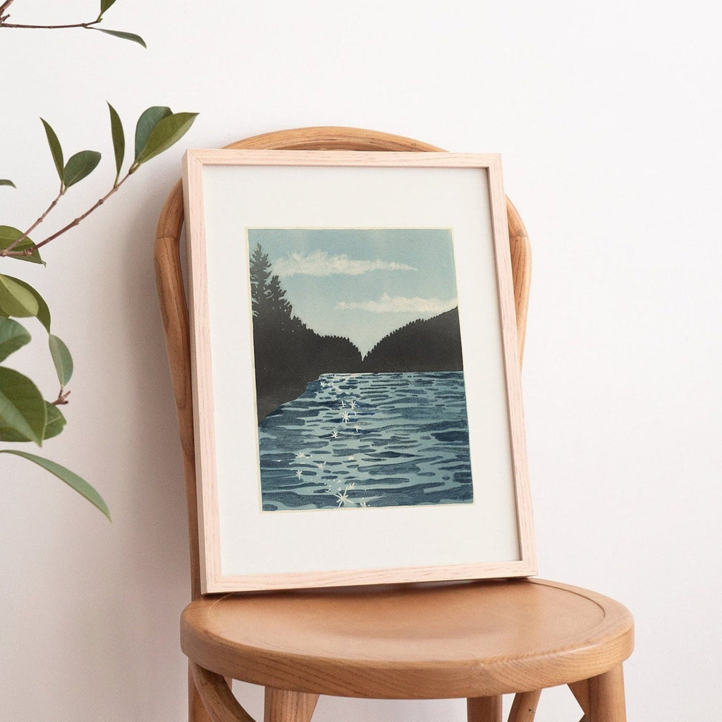 11X14 inch print of Lake Sutherland in a frame on a chair