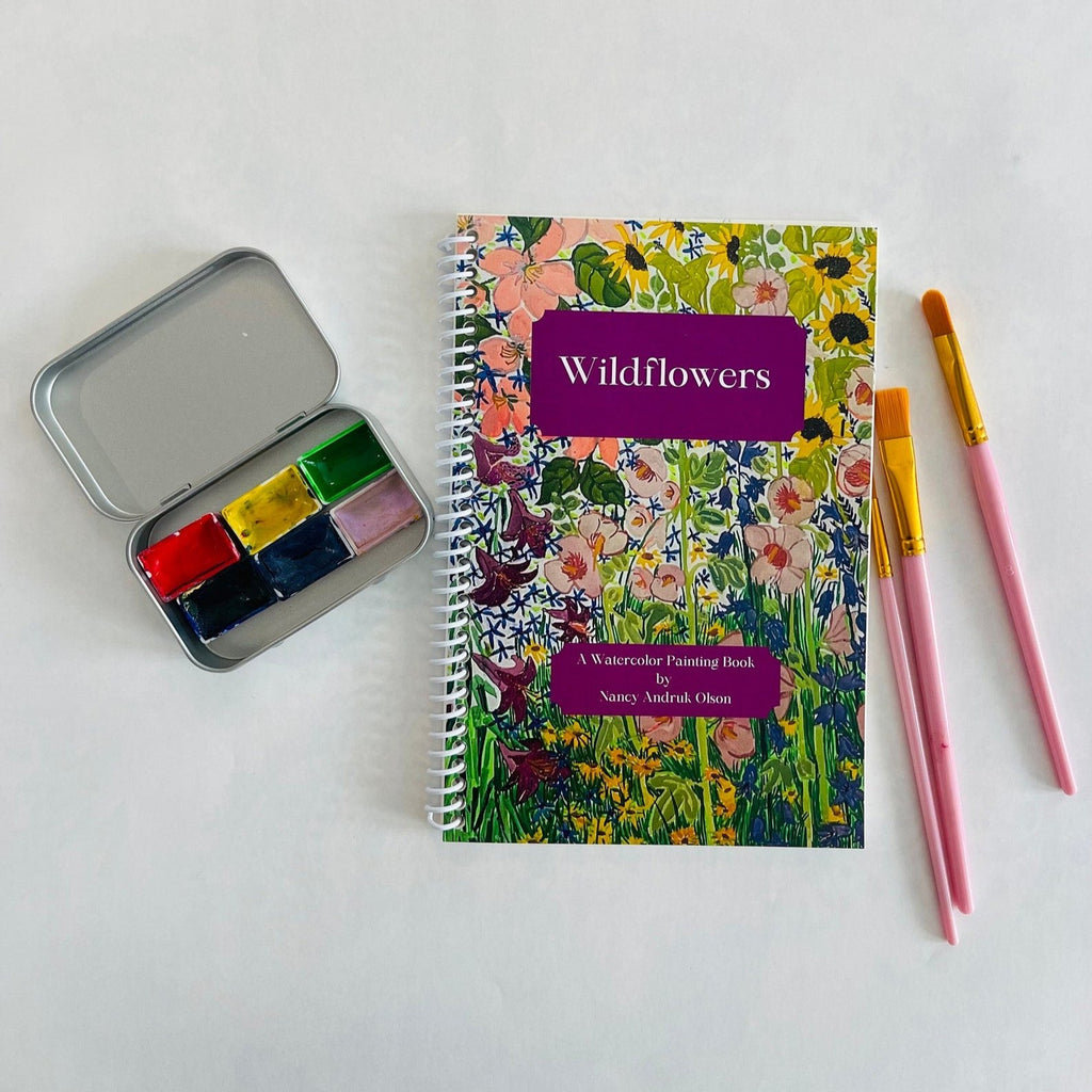 wildflower painting book with a tin of 6 watercolors and some paintbrushes