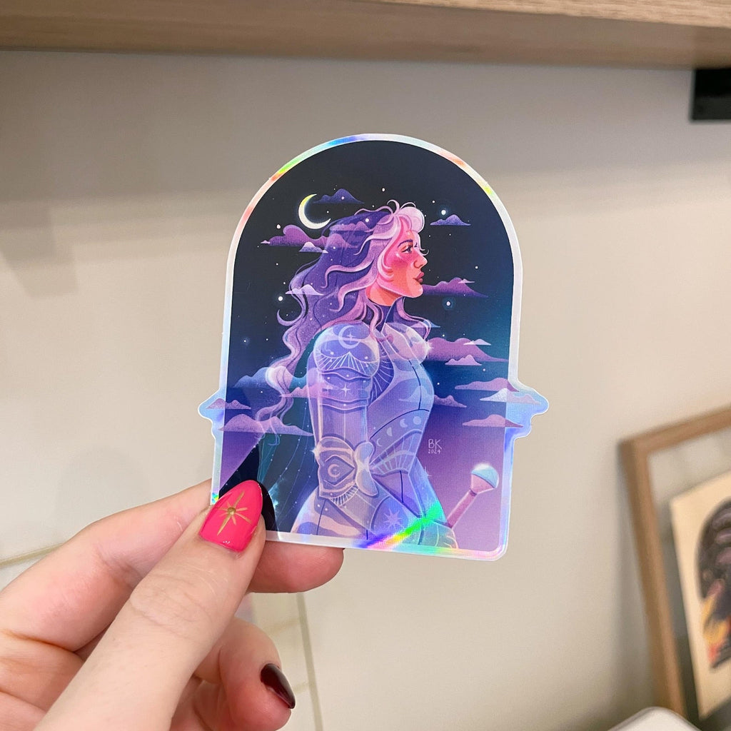 Moonlight Knight sticker based on artwork by Brittany Keller. This sticker has holographic elements and a glossy vinyl finish.