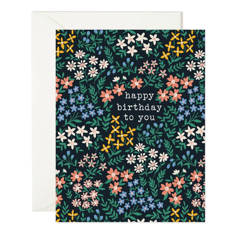 black card reading "happy birthday to you" covered in a wide variety of florals