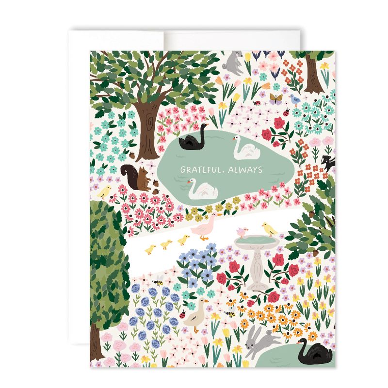 card featuring a whimsical garden scene with graceful swans and a playful squirrel. reading "grateful always"