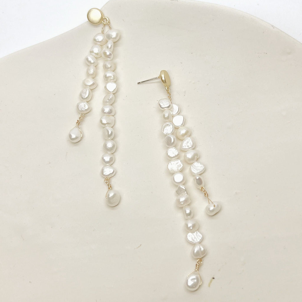 Add a touch of elegance to any outfit with our Double Strand Pearls. Crafted with gold plated steel and natural pearls, these versatile necklaces are sure to elevate your style.