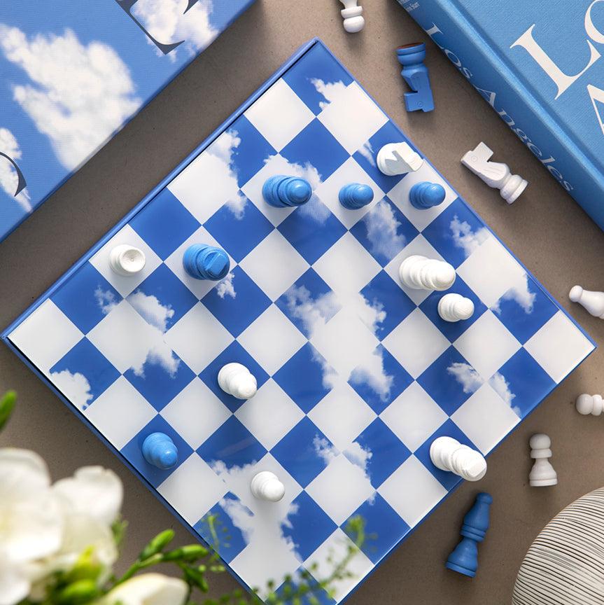 Discover our unique edition, "Chess Clouds", featuring a spectacular design inspired by the sky. The pieces and board are made of wood, with a thin layer of acrylic mounted on the board's surface, creating an impressive reflection. The box is crafted from high-quality art paper, adorned with a printed cloud formation, and enhanced with a hot foil print in navy and white.