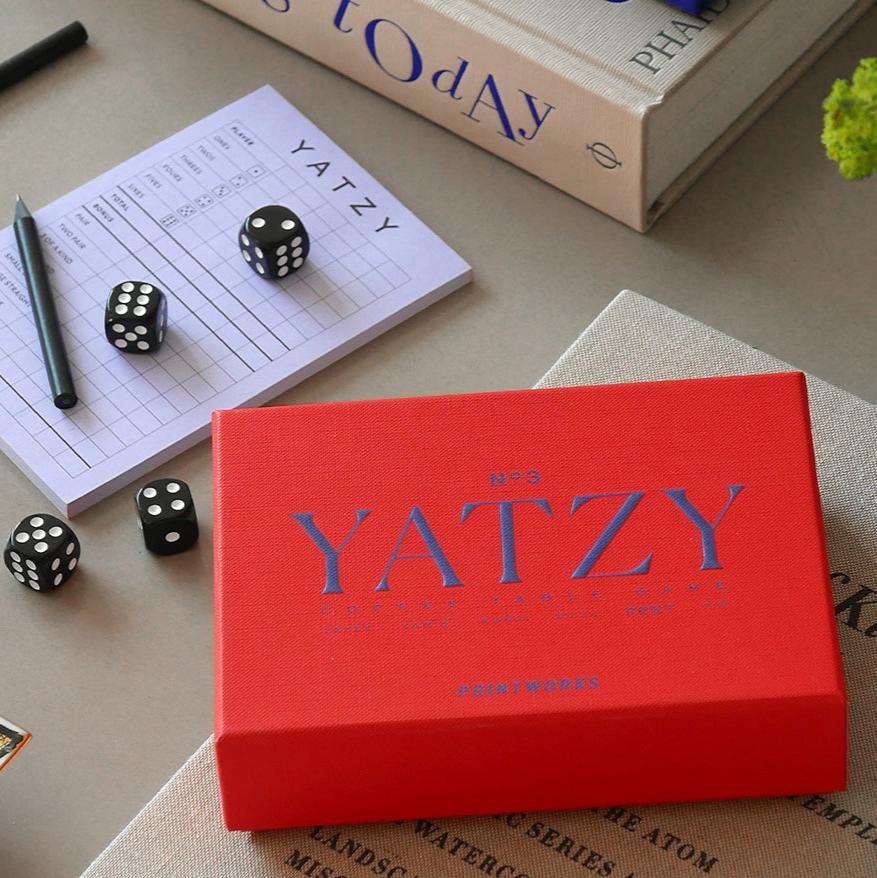 Discover a modern twist to your beloved game, Yatzy, where aesthetics meet entertainment. Our Yatzy Classic includes five black dice, two black pencils, and a 50-page scorecard. It has easy-to-read English, French, and German instructions and is suitable for up to 6 players, ages 4+